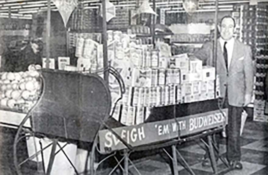 Frank next to a 'Sleigh 'em with Budweiser' cart.
